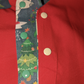 Christmas Dinosaur Reversible Waistcoat, fully reversible red or dinosaur front and back, popper fastening, available from newborn to age 10