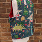 Christmas Dinosaur Reversible Waistcoat, fully reversible red or dinosaur front and back, popper fastening, available from newborn to age 10