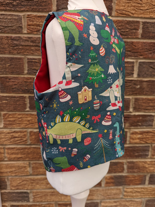 Christmas Dinosaur Reversible Waistcoat, fully reversible red or dinosaur front and back, popper fastening, available from newborn to age 10